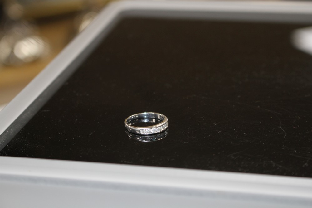 A modern 18ct white gold and seven stone diamond set half eternity ring, size L, gross weight 2.2 grams.